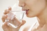 Young woman drinking glass of water